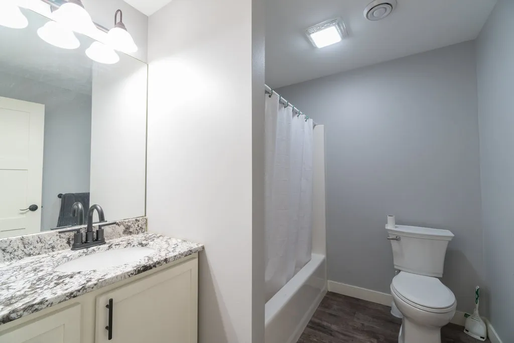 White vanity bathroom with granite countertop