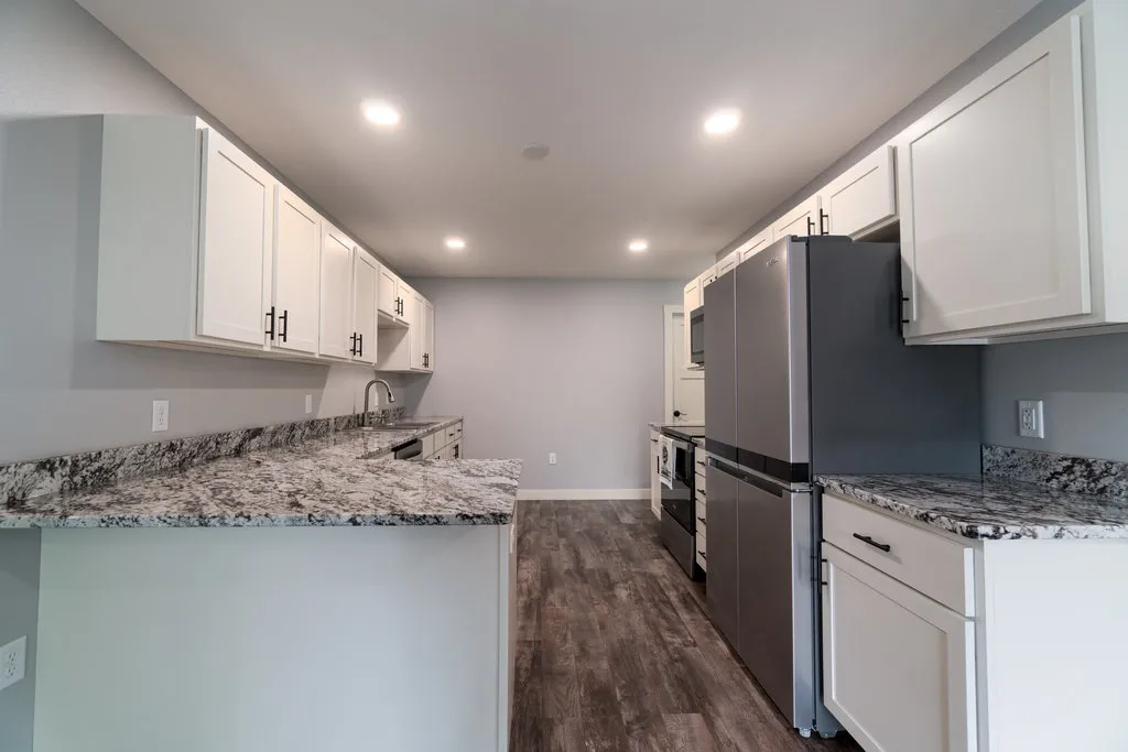 Kitchen with white cabinets and granite countertops, Altoona WI