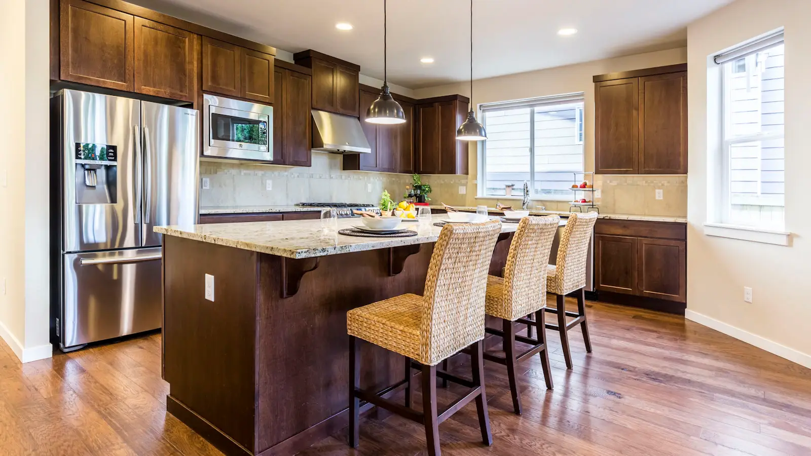 Residential kitchen remodel with wood cabinets, granite countertops, and stainless appliances